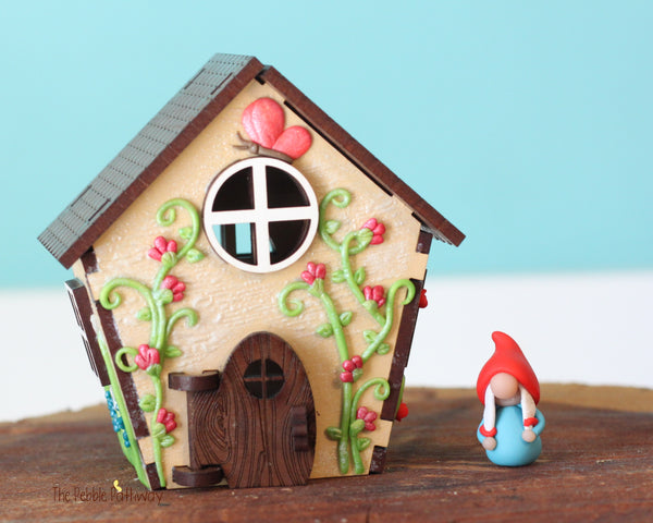 Tiny gnome home with itty bitty girl gnome - springtime miniature house with wildflowers