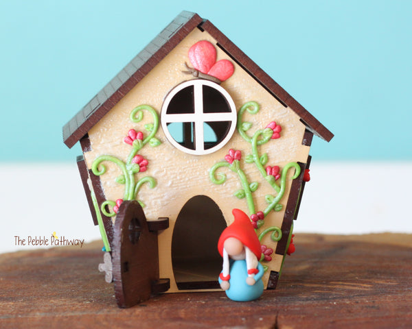 Tiny gnome home with itty bitty girl gnome - springtime miniature house with wildflowers