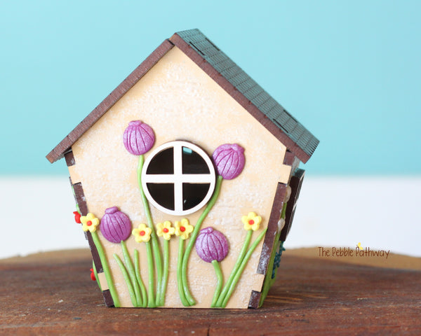 Tiny gnome home with itty bitty girl gnome - springtime miniature house with wildflowers