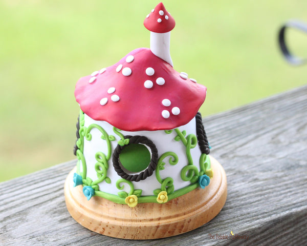 Mushroom Fairy House with vines and colorful flowers