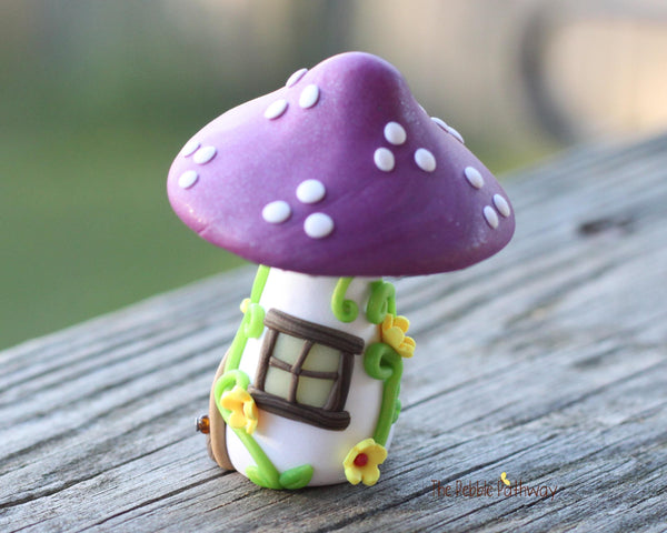 Tiny Purple mushroom gnome home with yellow flowers and vines