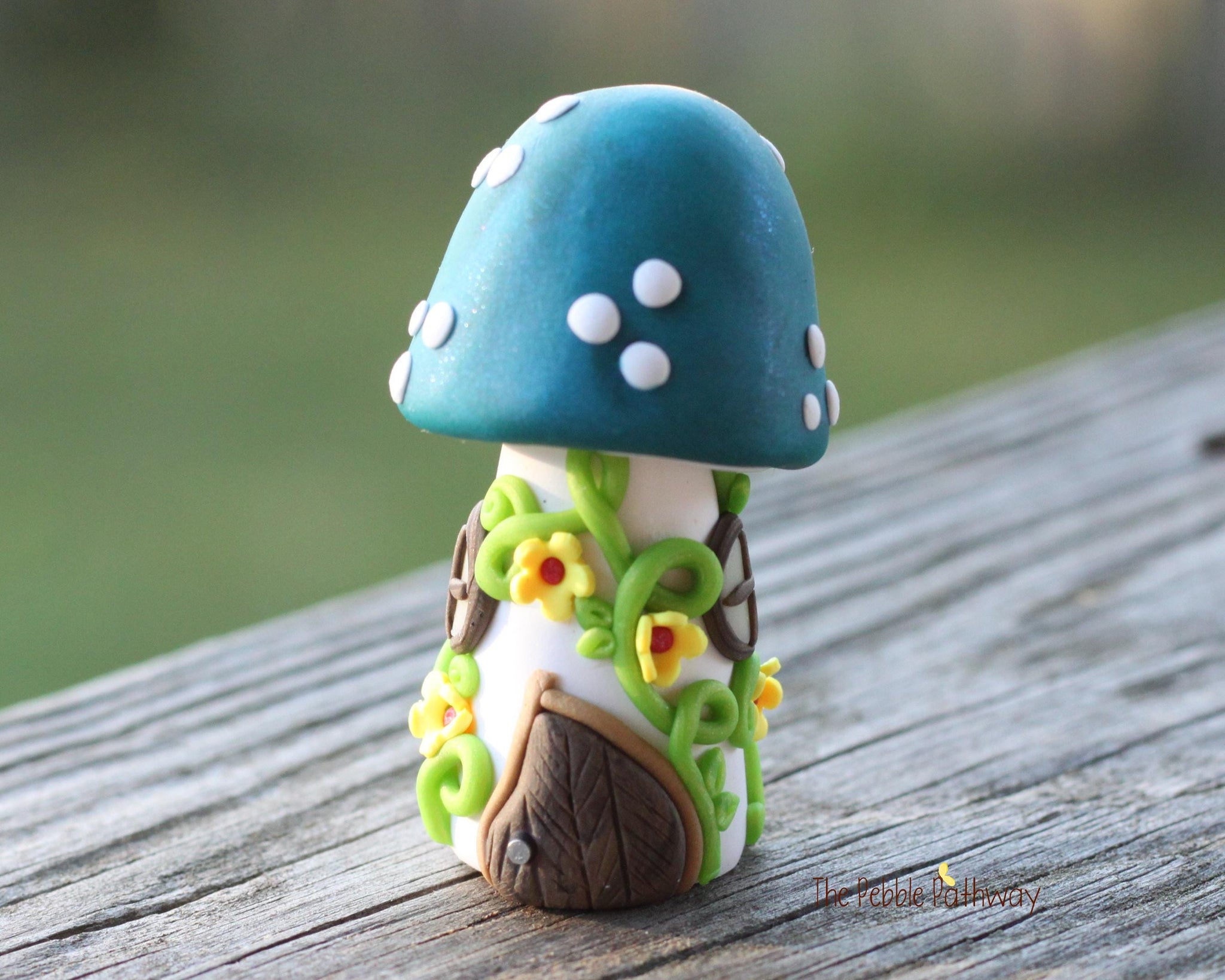 Tiny Blue mushroom gnome home with yellow flowers and vines