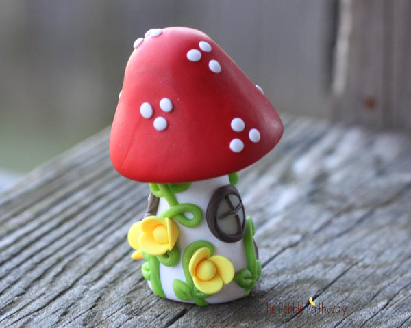 Tiny Red mushroom gnome home with yellow flowers and vines 2