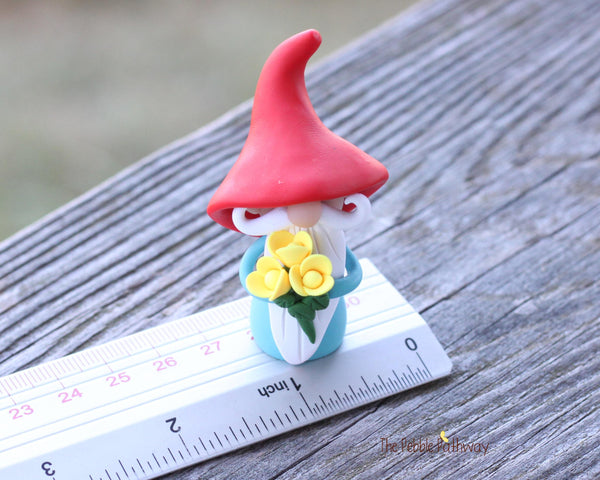 Gnome with bouquet of yellow flowers - miniature garden gnome figure