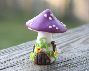 Tiny Purple mushroom gnome home with yellow flowers and vines