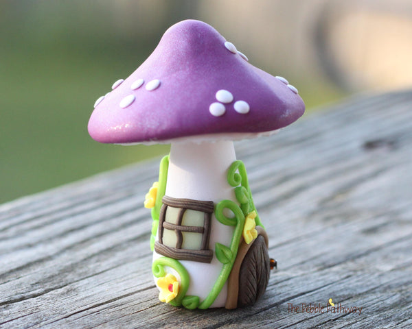 Tiny Purple mushroom gnome home with yellow flowers and vines