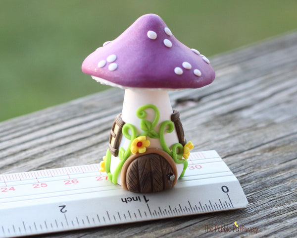 Tiny Purple mushroom gnome home with yellow flowers and vines