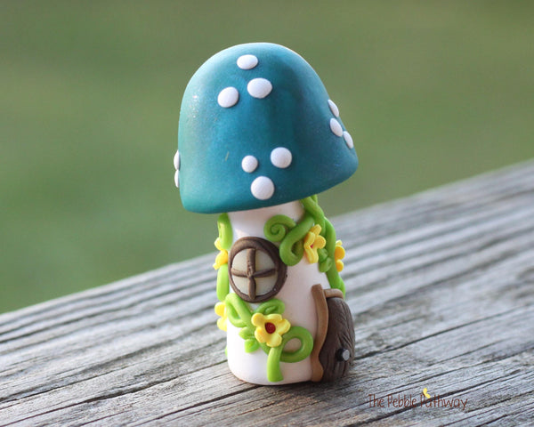 Tiny Blue mushroom gnome home with yellow flowers and vines