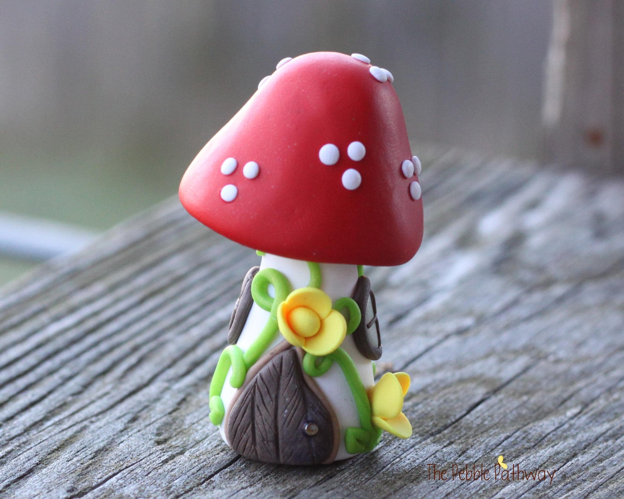 Tiny Red mushroom gnome home with yellow flowers and vines 2