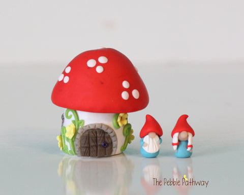 Tiny red mushroom gnome home with removable top and gnomes inside