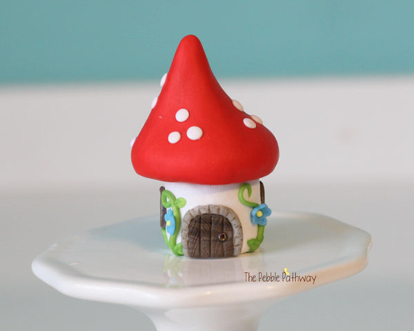 Tiny red mushroom with blue flowers gnome home with removable top and gnomes inside