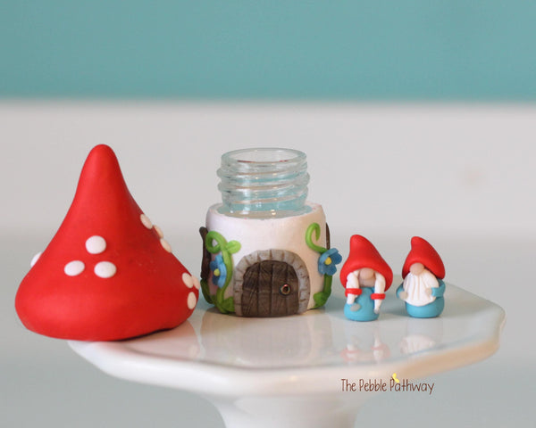 Tiny red mushroom with blue flowers gnome home with removable top and gnomes inside